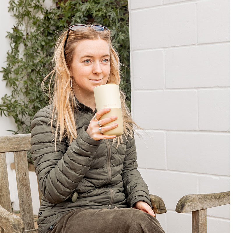 16oz-rise-tumbler-m9 16oz_rise_tumbler_wax_yellow_woman_seat_outside_square.jpg