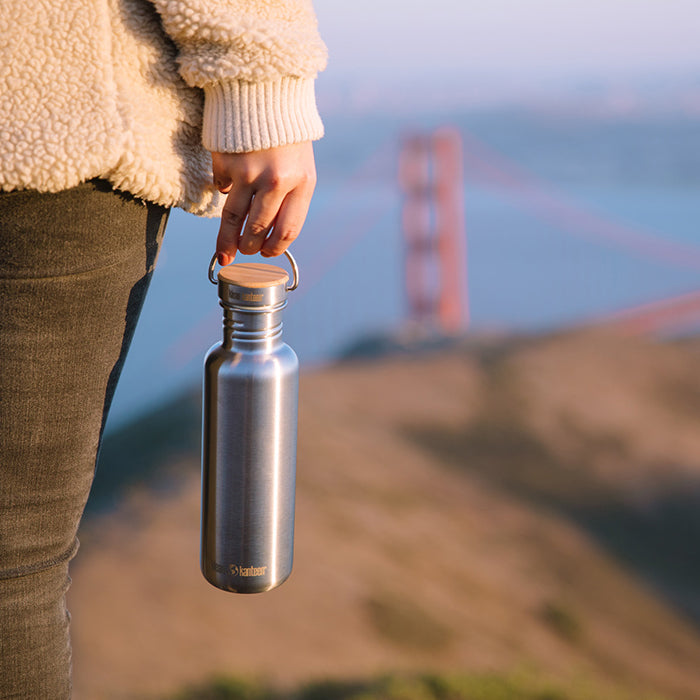 27oz-reflect-with-bamboo-cap-t3 K27SSLRF-BS-BAMBOO_reflect_bottle_bridge_lifestyle.jpg