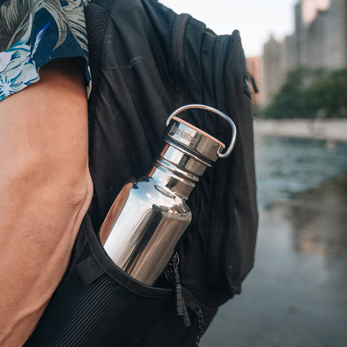 27oz-reflect-with-bamboo-cap-t3 K27SSLRF-MS-BAMBOO_reflect-bottle_backpack_lifestyle.jpg